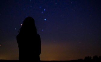 Frau schaut in den Himmel